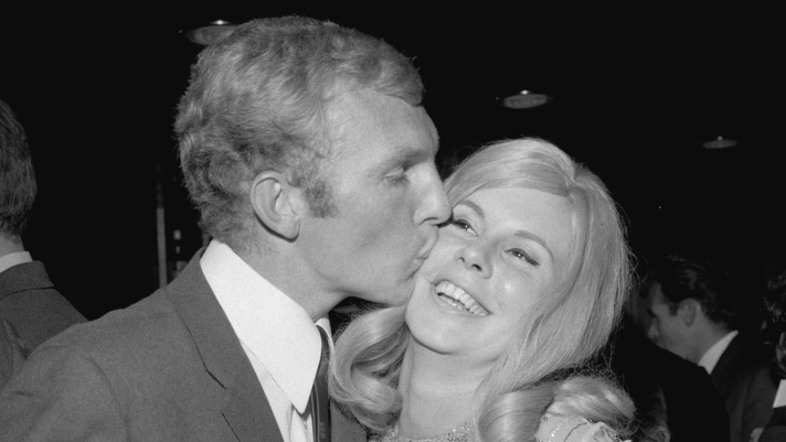 Bobby Moore kisses his wife Tina at a reception for the England football team after their World Cup victory, 31st July 1966. (Photo by Reg Burkett/Express/Getty Images)