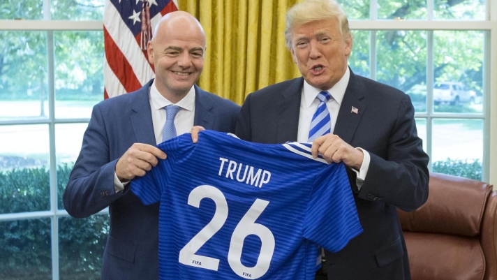 epa06979477 US President Donald J. Trump (R) holds up a FIFA soccer jersey presented to him by President of FIFA Gianni Infantino (L) during their meeting in the Oval Office of the White House in Washington, DC, USA, 28 August 2018. Along with the Canada and Mexico, the US will host the 2026 FIFA World Cup.  EPA/MICHAEL REYNOLDS