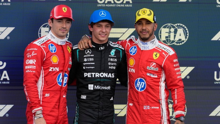 Mercedes driver Andrea Kimi Antonelli of Italy, center, poses with second placed Ferrari driver Charles Leclerc of Monaco, left, and third placed Ferrari driver Lewis Hamilton of Britain after clocked the fastest time during the qualifying session ahead of the British F1 Grand Prix, in Silverstone, England, Saturday, July 4, 2026. (AP Photo/Darko Bandic)