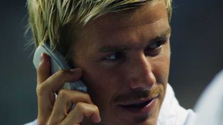 AMSTERDAM - AUGUST 4:  David Beckham of Manchester United makes a phone call during the Pre-Season Amsterdam Tournament match between Manchester United and Parma played at the Amsterdam ArenA, in Amsterdam, Holland on August 4, 2002. Manchester United won the match 3-0. DIGITAL IMAGE. (Photo by Ben Radford/Getty Images)