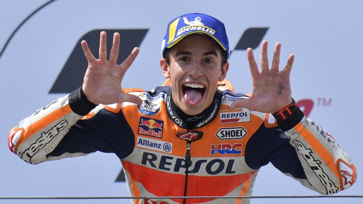 Repsol Honda Team's Spanish rider Marc Marquez shows the number 10 with his hands (the number of his victories) as he celebrates on the podium after winning the Moto GP Grand Prix Germany at the Sachsenring Circuit on July 7, 2019 in Hohenstein-Ernstthal, eastern Germany. (Photo by Tobias SCHWARZ / AFP)
