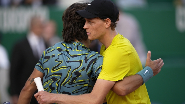 Jannik Sinner, of Italy, right, and Lorenzo Musetti, also of Italy, embrace at the end of their Monte Carlo Tennis Masters quarterfinals match in Monaco, Friday, April 14, 2023. Sinner won 6/2, 6/2. (AP Photo/Daniel Cole)