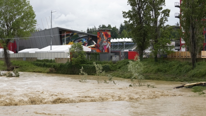 A view of the swollen Santerno River with behind the Enzo e Dino Ferrari circuit, in Imola, Italy, Wednesday, May 17, 2023. The weekend's Emilia-Romagna Grand Prix in Imola has been canceled because of deadly floods. Formula One said it made the decision for safety reasons and to avoid any extra burden on the emergency services. F1 personnel had earlier been told to stay away from the track after floods affected large parts of the Emilia-Romagna region. (AP Photo/Luca Bruno)