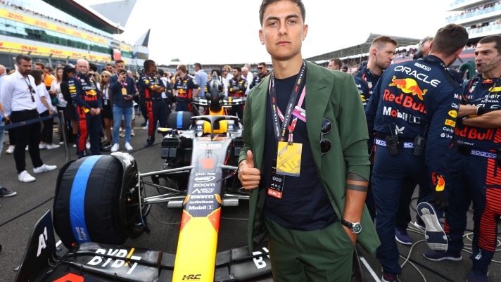 NORTHAMPTON, ENGLAND - JULY 09: Paulo Dybala poses for a photo with the car of Max Verstappen of the Netherlands and Oracle Red Bull Racing on the grid during the F1 Grand Prix of Great Britain at Silverstone Circuit on July 09, 2023 in Northampton, England. (Photo by Mark Thompson/Getty Images)