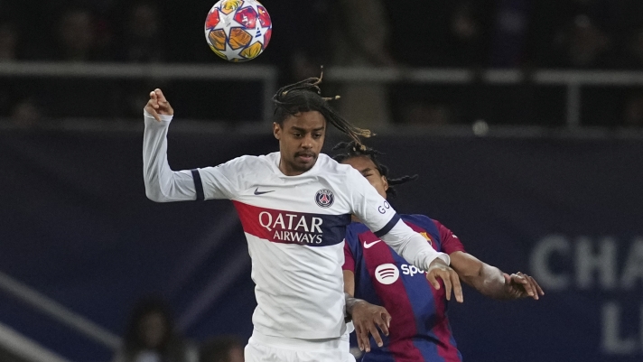 PSG's Bradley Barcola, left, jumps for the ball with Barcelona's Jules Kounde during the Champions League quarterfinal second leg soccer match between Barcelona and Paris Saint-Germain at the Olimpic Lluis Companys stadium in Barcelona, Spain, Tuesday, April 16, 2024. (AP Photo/Emilio Morenatti)