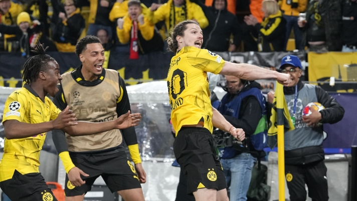 Dortmund's Marcel Sabitzer, right, celebrates in front of supporters after scoring the decisive goal during the Champions League quarterfinal second leg soccer match between Borussia Dortmund and Atletico Madrid at the Signal-Iduna Park in Dortmund, Germany, Tuesday, April 16, 2024(AP Photo/Martin Meissner)