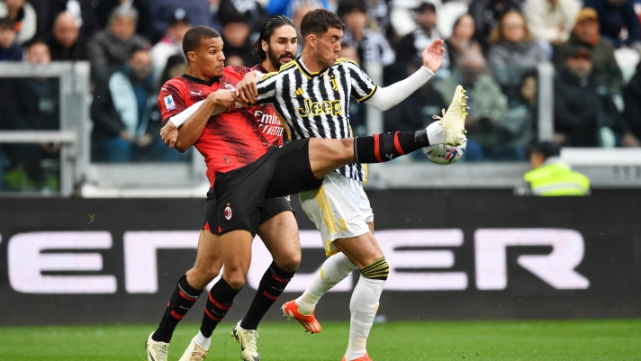 TURIN, ITALY - APRIL 27: Dusan Vlahovic of Juventus is challenged by Malick Thiaw of AC Milan during the Serie A TIM match between Juventus and AC Milan at Allianz Stadium on April 27, 2024 in Turin, Italy. (Photo by Valerio Pennicino/Getty Images)