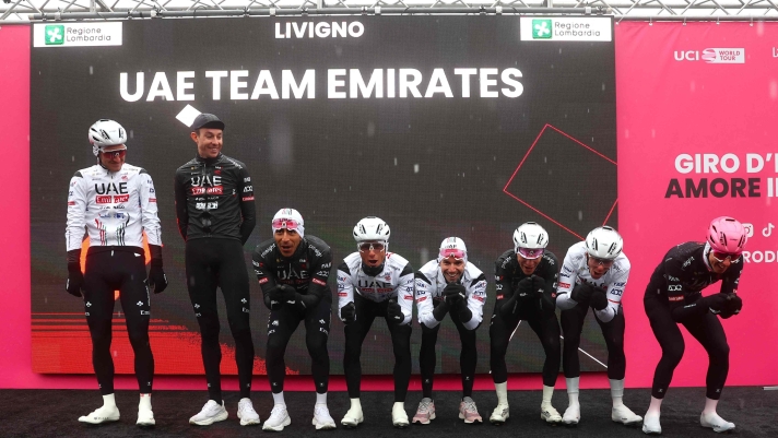 Team UAE's Slovenian rider Tadej Pogacar (R) and his teammates gesture during the presentation of the teams prior the 16th stage of the 107th Giro d'Italia cycling race, 206km between Livigno and Santa Cristina Val Gardena on May 21, 2024. (Photo by Luca Bettini / AFP)