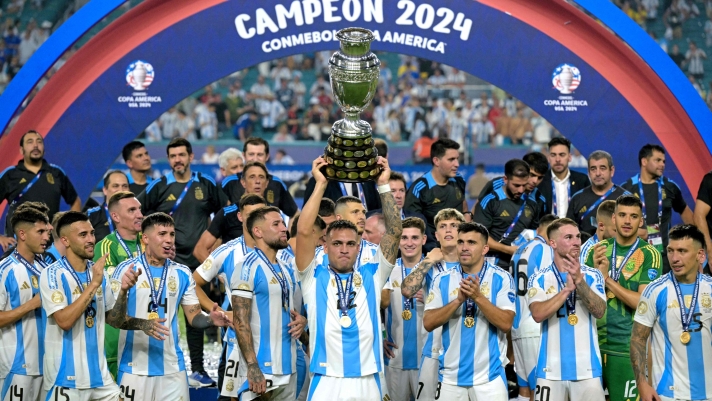 Argentina's forward #22 Lautaro Martinez lifts up the trophy as he celebrates winning the Conmebol 2024 Copa America tournament final football match between Argentina and Colombia at the Hard Rock Stadium, in Miami, Florida on July 14, 2024. (Photo by JUAN MABROMATA / AFP)