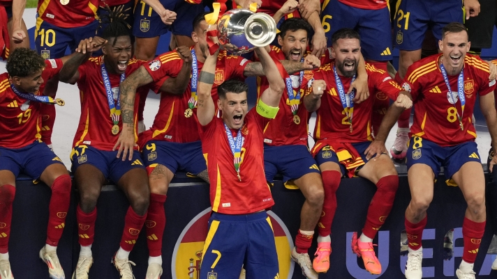 Spain's Alvaro Morata lifts the trophy after winning the final match between Spain and England at the Euro 2024 soccer tournament in Berlin, Germany, Sunday, July 14, 2024. (AP Photo/Andreea Alexandru)