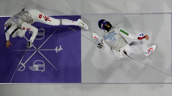 Hong Kong's Cheung Ka long, left, competes with Italy's Filippo Macchi in the men's individual Foil final match at the 2024 Summer Olympics, Monday, July 29, 2024, in Paris, France. (AP Photo/Christophe Ena)