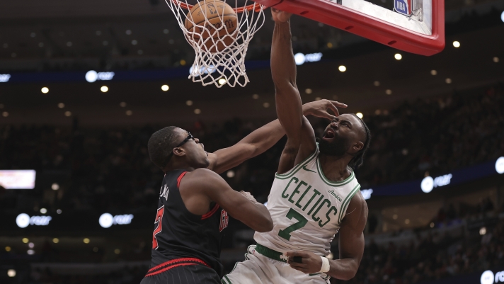 Boston Celtics guard Jaylen Brown slam dunks over Chicago Bulls forward Jalen Smith during the second half of an Emirates NBA Cup basketball game, Friday Nov. 29, 2024, in Chicago. (AP Photo/Melissa Tamez)