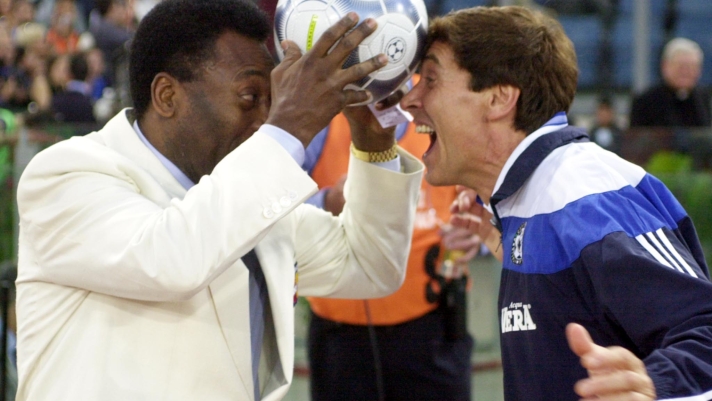 Brazil's soccer legend Pele', left, jokes with Italian pop start Gianni Morandi prior to the start of the "Match of the Heart 2000" exhibition soccer match between the Nazionale Italiana Cantanti (the Italian Singers Team) and a team composed by Israeli and Palestinian players in Rome's Olympic stadium, Thursday, May 25, 2000. The match was organized to raise funds for two peacebuilding projects carried out in partnership by the Peres Center for peace and Palestinian authorities. (AP Photo/Andrew Medichini)