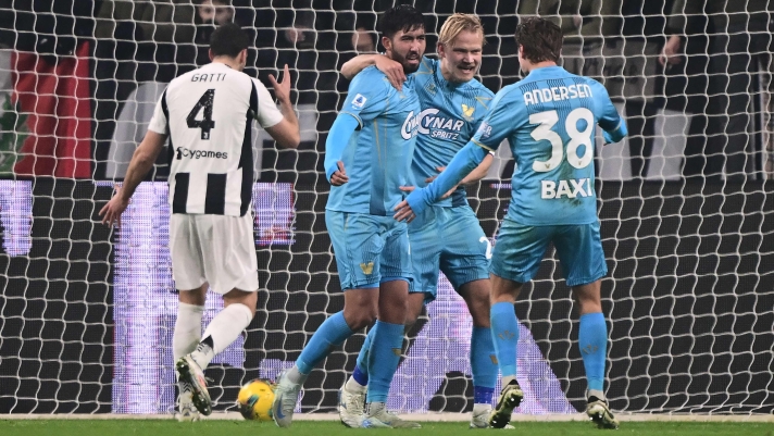 Venezia's Icelandic midfielder #77 Mikael Egill Ellertsson (2nd L) celebrates after scoring a goal during the Italian Serie A football match between Juventus FC and Venezia FC at the Allianz Stadium in Turin, on December 14, 2024. (Photo by MARCO BERTORELLO / AFP)