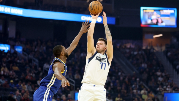 SAN FRANCISCO, CALIFORNIA - DECEMBER 15: Luka Doncic #77 of the Dallas Mavericks goes up for a shot on Andrew Wiggins #22of the Golden State Warriors at Chase Center on December 15, 2024 in San Francisco, California. NOTE TO USER: User expressly acknowledges and agrees that, by downloading and/or using this photograph, user is consenting to the terms and conditions of the Getty Images License Agreement.   Ezra Shaw/Getty Images/AFP (Photo by EZRA SHAW / GETTY IMAGES NORTH AMERICA / Getty Images via AFP)