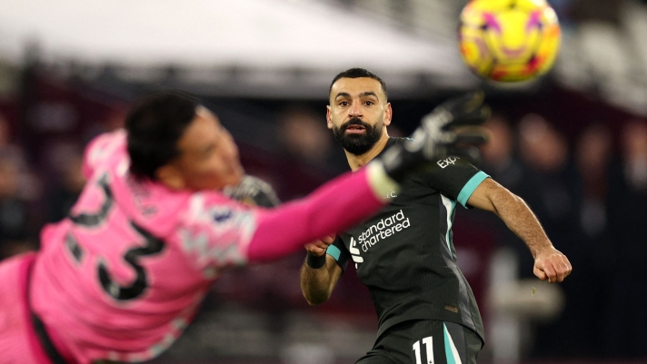 TOPSHOT - Liverpool's Egyptian striker #11 Mohamed Salah looks on as West Ham United's French goalkeeper #23 Alphonse Areola saves his shot during the English Premier League football match between West Ham United and Liverpool at the London Stadium, in London on December 29, 2024. (Photo by Adrian Dennis / AFP) / RESTRICTED TO EDITORIAL USE. No use with unauthorized audio, video, data, fixture lists, club/league logos or 'live' services. Online in-match use limited to 120 images. An additional 40 images may be used in extra time. No video emulation. Social media in-match use limited to 120 images. An additional 40 images may be used in extra time. No use in betting publications, games or single club/league/player publications. /