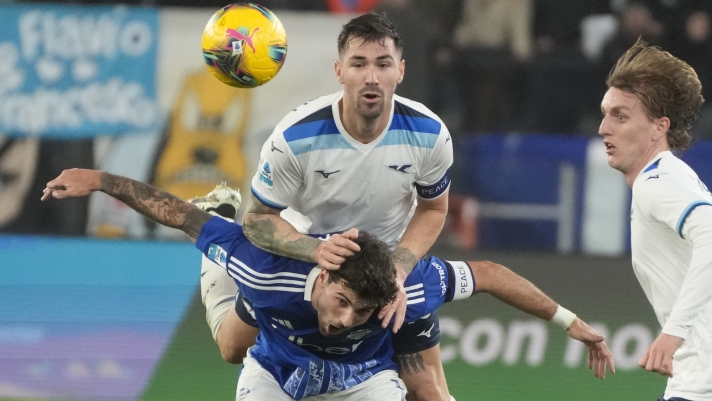 Lazio's Alessio Romagnoli, top, and Como's Patrick Cutrone challenge for the ball during the Italian Serie A soccer match between Lazio and Como at Rome's Olympic stadium, Friday, Jan. 10, 2025. (AP Photo/Gregorio Borgia)