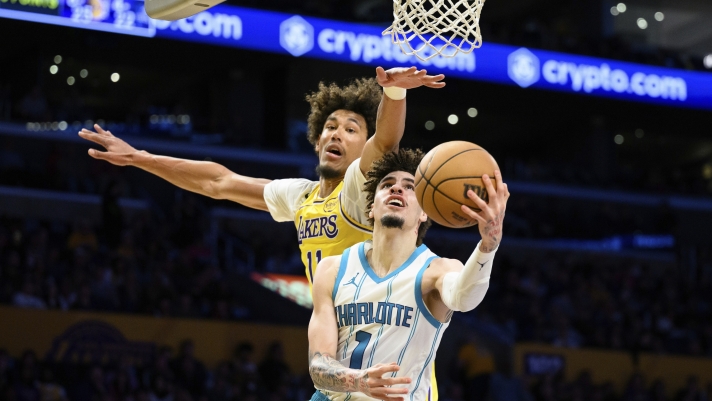 Charlotte Hornets guard LaMelo Ball (1) shoots the ball while under pressure from Los Angeles Lakers center Jaxson Hayes during the first half of an NBA basketball game Wednesday, Feb. 19, 2025, in Los Angeles. (AP Photo/William Liang)