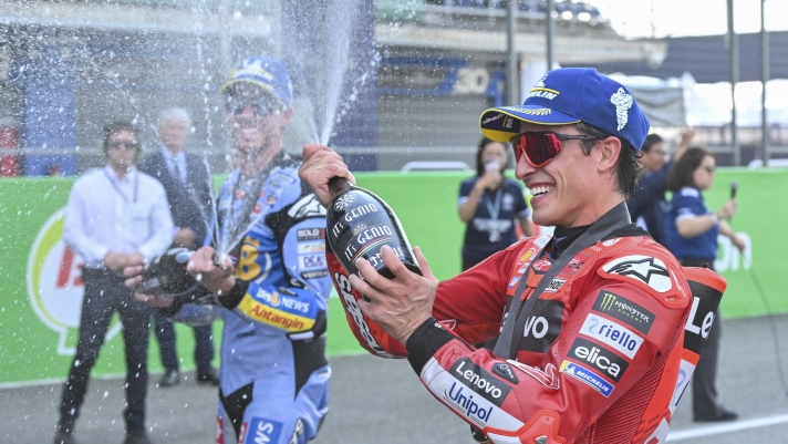 Spain's rider Marc Marquez, right, celebrates after winning the MotoGP sprint race at the Chang International Circuit in Buriram, Thailand, Saturday, March 1, 2025. (AP Photo/Kittinun Rodsupan)