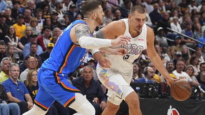 Denver Nuggets center Nikola Jokic, right, drives past Oklahoma City Thunder center Isaiah Hartenstein in the first half of Game 6 in the Western Conference semifinals of the NBA basketball playoffs Thursday, May 15, 2025, in Denver. (AP Photo/David Zalubowski)