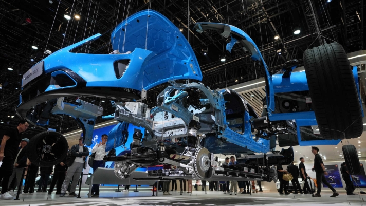 Visitors look at a SU7 model from Chinese automaker Xiaomi dismantled apart is showcased at the Auto China 2026, in Beijing, Saturday, April 25, 2026. (AP Photo/Andy Wong)