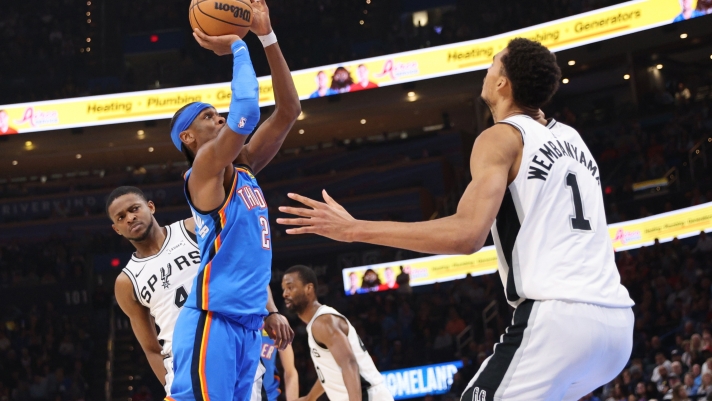 Oklahoma City Thunder guard Shai Gilgeous-Alexander (2) looks to shoot between San Antonio Spurs guard De'aaron Fox, left, and forward Victor Wembanyama (1) during the second half of an NBA basketball game Tuesday, Jan. 13, 2026, in Oklahoma City. (AP Photo/Nate Billings)   Associated Press / LaPresse Only italy and spain