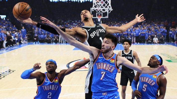 San Antonio Spurs forward Victor Wembanyama (1) and Oklahoma City Thunder center Chet Holmgren (7) reach for a rebound during the first half of Game 1 in a third-round NBA basketball playoffs series Monday, May 18, 2026, in Oklahoma City. (AP Photo/Nate Billings)