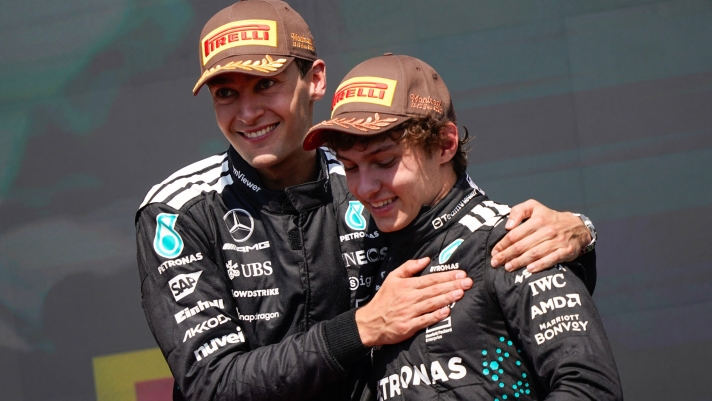 TOPSHOT - (L/R) Race winner Mercedes' British driver George Russell celebrates with teammate and third place finisher Mercedes' Italian driver Kimi Antonelli on the podium after the 2025 Formula 1 Grand Prix du Canada at Circuit Gilles-Villeneuve in Montreal, Canada, on June 15, 2025. (Photo by Geoff Robins / AFP)