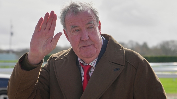 TV presenter Jeremy Clarkson waves to the media as he arrives on day four of the 2026 Cheltenham Festival in Cheltenham, England, Friday, March 13, 2026. (AP Photo/Dave Shopland)