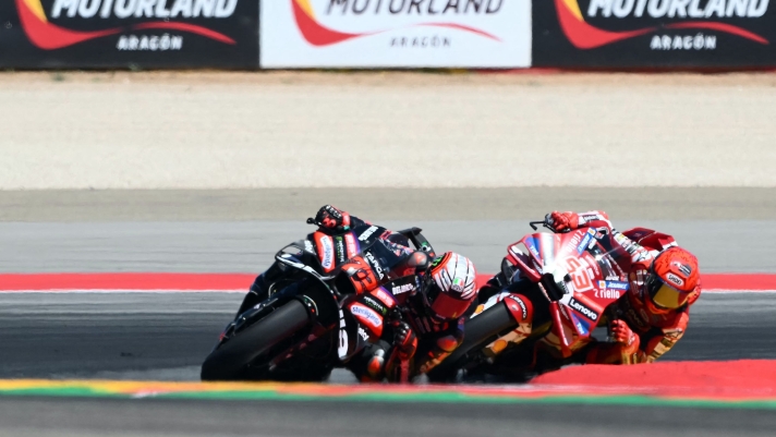 Team Aprilia Racing's Marco Bezzecchi (L) and Team Ducati Lenovo Team's Marc Marquez compete in the MotoGP race during the Aragon MotoGP Grand Prix at the Motorland circuit in Alcaniz, northeastern Spain, on August 30, 2026. (Photo by JOSE JORDAN / AFP)
