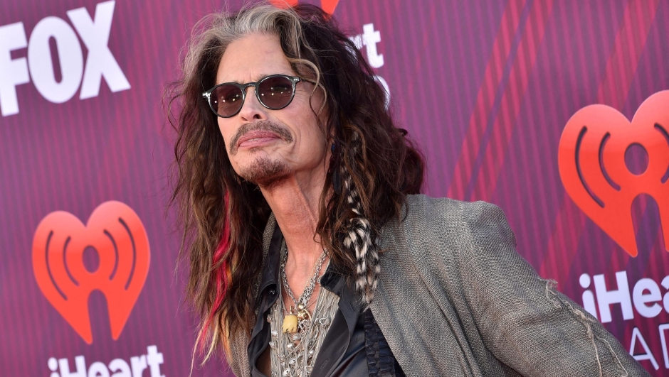 (FILES) In this file photo taken on March 14, 2019, US singer-songwriter Steven Tyler arrives for the 2019 iHeart Radio Music Awards at the Microsoft Theatre in Los Angeles. - Aerosmith frontman Steven Tyler is facing a lawsuit by a woman who claims he sexually assaulted her as a minor during a years-long relationship in the 1970s. Claimant Julia Holcomb, who is now 65, alleges "American Idol" judge Tyler was granted guardianship of her when she was 16, which he used to engage in a sexual relationship. (Photo by Chris Delmas / AFP)