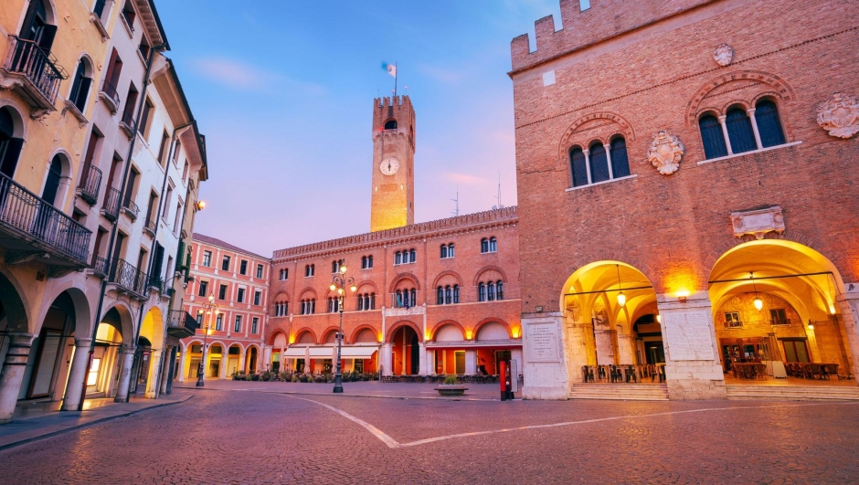 Cityscape image of historical center of Treviso, Italy with old square at sunrise.
