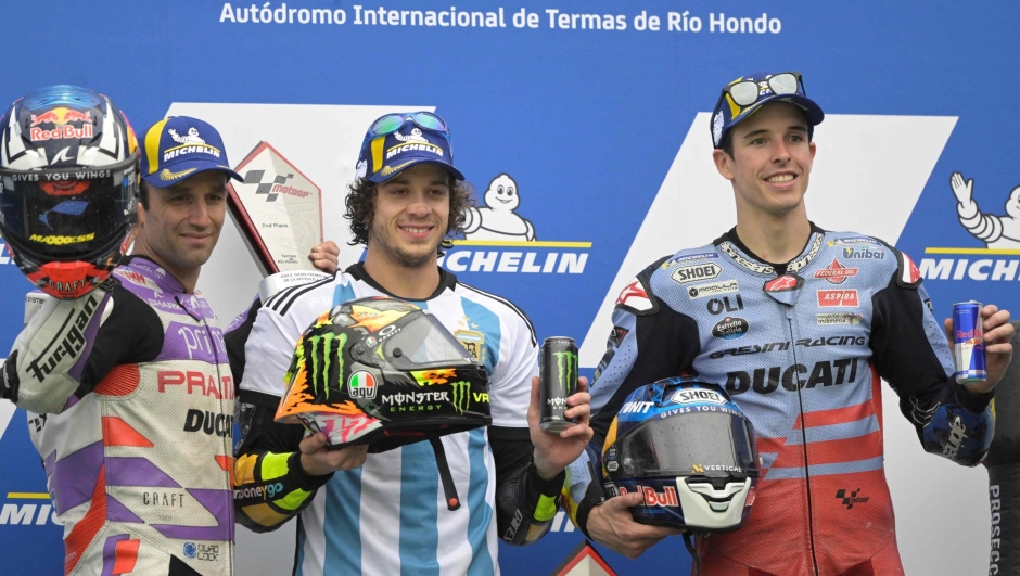 (L to R) Ducati French rider Johann Zarco, Ducati Italian rider Marco Bezzecchi, and Ducati Spanish rider Alex Marquez celebrate their second, first, and third place respectively, on the podium of the Argentina Grand Prix MotoGP race, at Termas de Rio Hondo circuit in Santiago del Estero, Argentina, on April 2, 2023. (Photo by JUAN MABROMATA / AFP)