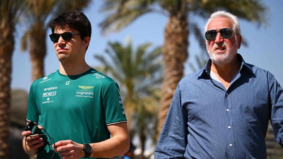 BAHRAIN, BAHRAIN - MARCH 02: Lance Stroll of Canada and Aston Martin F1 Team and Owner of Aston Martin F1 Team Lawrence Stroll talk in the Paddock during previews ahead of the F1 Grand Prix of Bahrain at Bahrain International Circuit on March 02, 2023 in Bahrain, Bahrain. (Photo by Clive Mason/Getty Images)