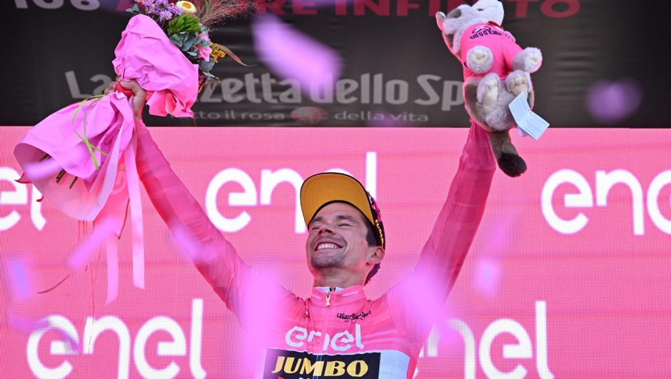 Slovenian rider  Primoz Roglic of team Jumbo Visma team wearing the overall leader's pink jersey celebrates on the podium the overall leader's pink jersey after  the twentyth stage ITT of the 2023 Giro d'Italia cycling race over  km 18,6 from Tarvisio to Monte Lussari, Italy, 27May 2023. ANSA/LUCA
