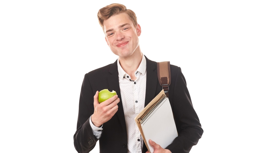 Portrait of handsome high school student posing in studio against white background