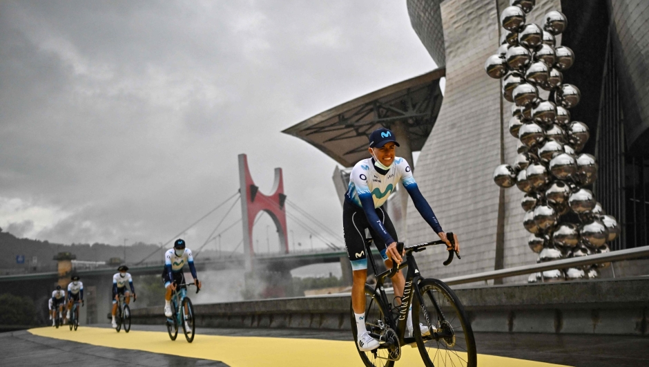 Movistar Team's Spanish rider Enric Mas cycles to the stage during the official teams presentation near the Guggenheim Museum Bilbao, in Bilbao, northern Spain, on June 29, 2023, two days prior to the start of the 110th edition of the Tour de France cycling race. (Photo by Marco BERTORELLO / AFP)