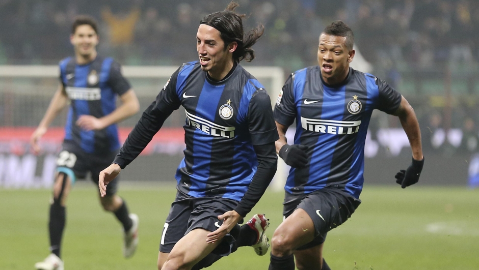 Inter Milan midfielder Ezequiel Schelotto, left, of Argentina, celebrates with his teammate Colombian midfielder Fredy Guarin after scoring during the Serie A soccer match between Inter Milan and AC Milan at the San Siro stadium in Milan, Italy, Sunday, Feb. 24, 2013. (AP Photo/Antonio Calanni)