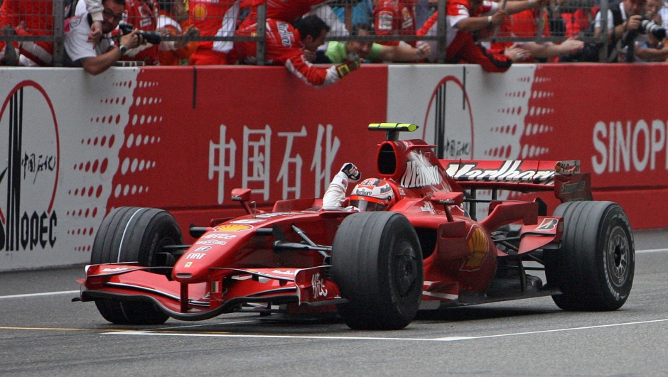 Finnish driver Kimi Raikkonen from the Ferrari team celebrates after crossing the finish line and winning the Formula One Chinese Grand Prix at the Shanghai International Circuit, 07 October 2007. Formula One's world championship was blown wide open after Lewis Hamilton dramatically slid into a gravel trap in the Chinese Grand Prix and Kimi Raikkonen snatched victory for Ferrari.   AFP PHOTO/Mark RALSTON