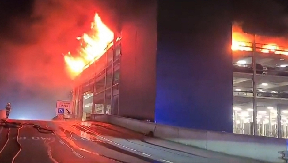 This frame grab from handout video footage taken and released by the Bedfordshire Fire and Rescue Service via AFPTV on October 11, 2023 shows a parking structure on fire at London's Luton Airport. Five people, including four firefighters and an airport employee, were admitted to hospital, according to the local ambulance service. (Photo by Handout / various sources / AFP) / RESTRICTED TO EDITORIAL USE - MANDATORY CREDIT "AFP PHOTO /  Bedfordshire Fire and Rescue Service" - NO MARKETING - NO ADVERTISING CAMPAIGNS - DISTRIBUTED AS A SERVICE TO CLIENTS