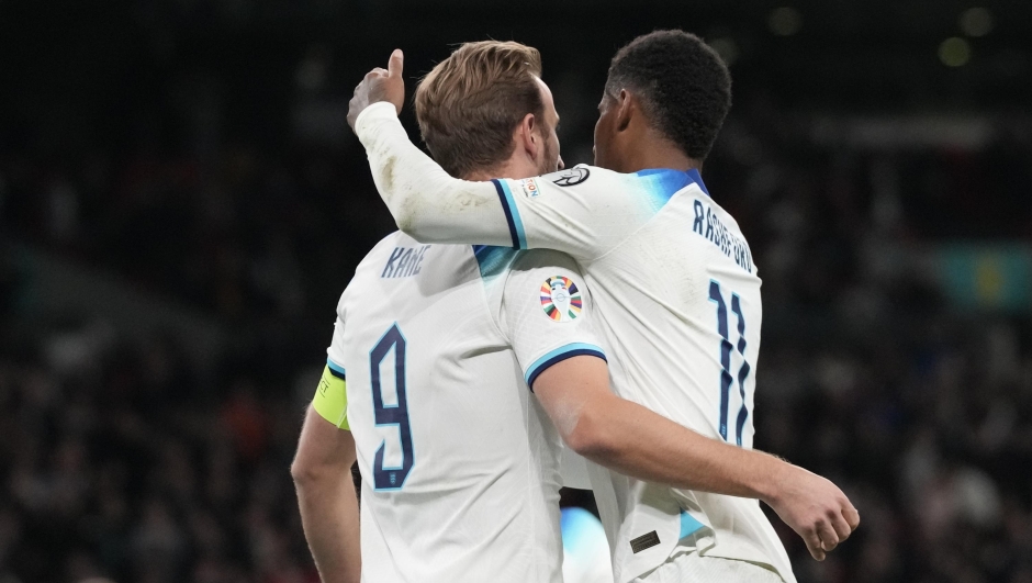 England's Harry Kane, right, celebrates with England's Marcus Rashford after scoring his side's opening goal from a penalty kick during the Euro 2024 group C qualifying soccer match between England and Italy at Wembley stadium in London, Tuesday, Oct. 17, 2023. (AP Photo/Frank Augstein)