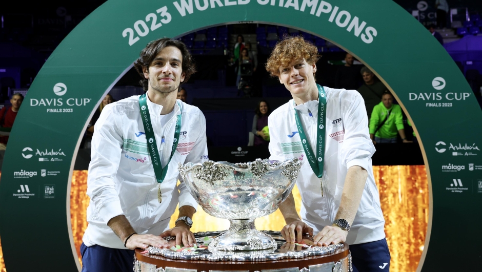 MALAGA, SPAIN - NOVEMBER 26: Lorenzo Musetti and Jannik Sinner of Italy celebrate with the Davis Cup Trophy after their teams victory during the Davis Cup Final match against Australia at Palacio de Deportes Jose Maria Martin Carpena on November 26, 2023 in Malaga, Spain. (Photo by Clive Brunskill/Getty Images for ITF)
