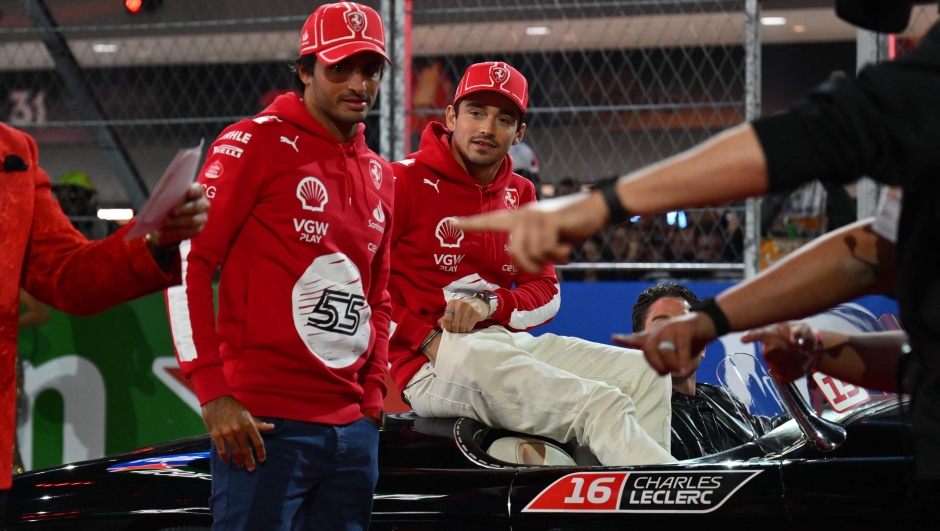 Ferrari's Spanish driver Carlos Sainz Jr., (L) and Ferrari's Monegasque driver Charles Leclerc take part in the drivers' parade ahead of the Las Vegas Formula One Grand Prix on November 18, 2023, in Las Vegas, Nevada. (Photo by ANGELA WEISS / AFP)