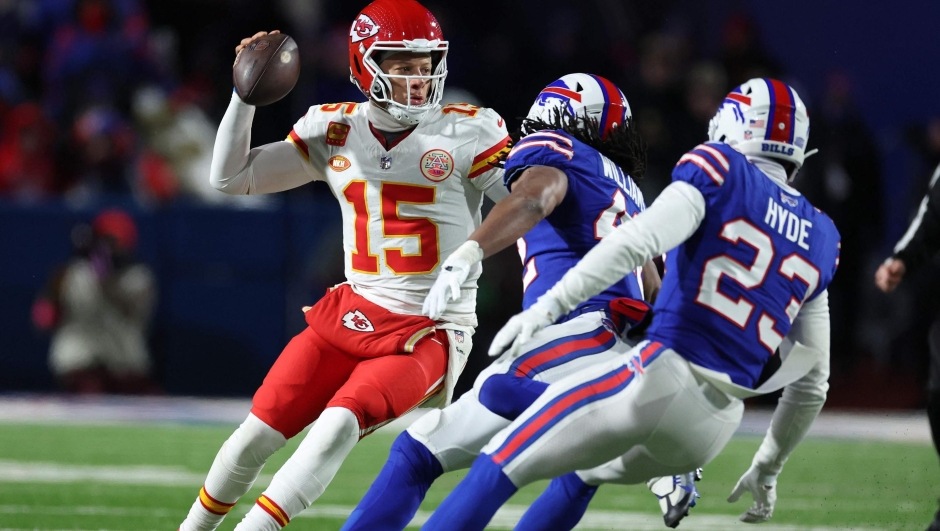 ORCHARD PARK, NEW YORK - JANUARY 21: Patrick Mahomes #15 of the Kansas City Chiefs dodges Micah Hyde #23 of the Buffalo Bills during their AFC Divisional Playoff game at Highmark Stadium on January 21, 2024 in Orchard Park, New York.   Al Bello/Getty Images/AFP (Photo by AL BELLO / GETTY IMAGES NORTH AMERICA / Getty Images via AFP)