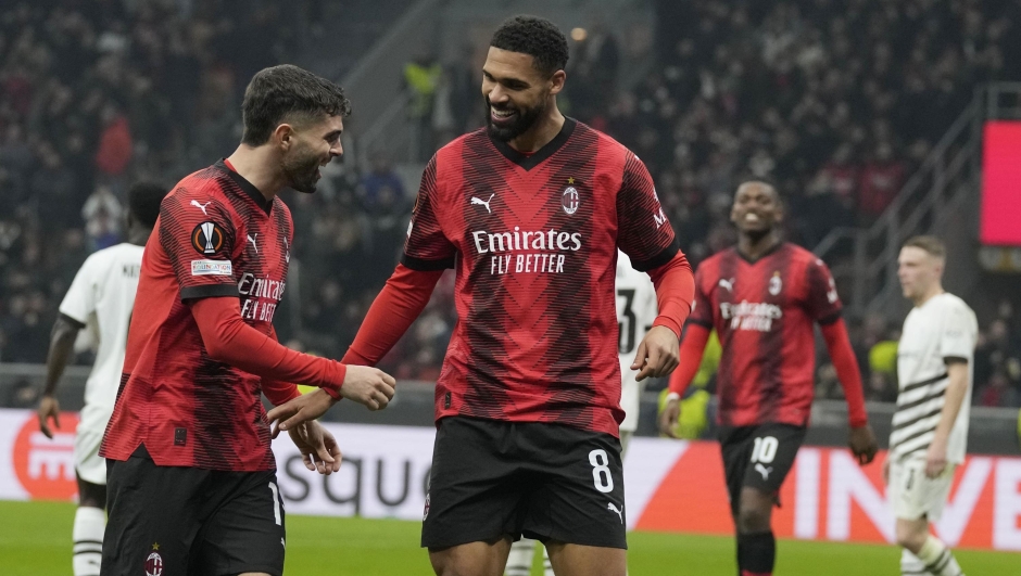 AC Milan's Ruben Loftus-Cheek celebrates with his teammate Christian Pulisic after scoring his side's second goal during the Europa League play-off first leg soccer match between AC Milan and Rennes at the San Siro Stadium, in Milan, Italy, Thursday, Feb. 15, 2024. (AP Photo/Antonio Calanni)