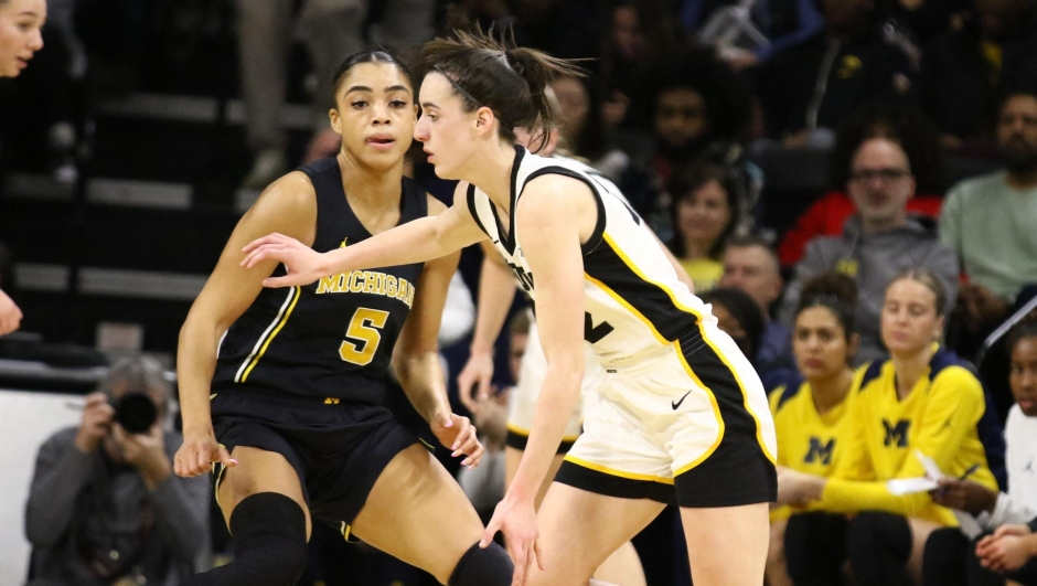 IOWA CITY, IOWA- FEBRUARY 15: Guard Caitlin Clark #22 of the Iowa Hawkeyes goes to the basket during the first half against guard Laila Phelia #5 of the Michigan Wolverines at Carver-Hawkeye Arena on February 15, 2024 in Iowa City, Iowa.   Matthew Holst/Getty Images/AFP (Photo by Matthew Holst / GETTY IMAGES NORTH AMERICA / Getty Images via AFP)