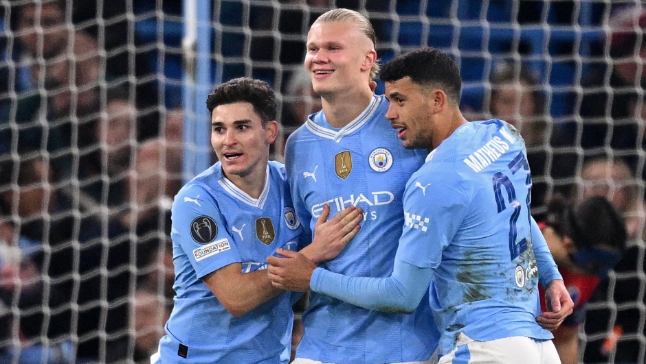 TOPSHOT - Manchester City's Norwegian striker #09 Erling Haaland (C) celebrates with Manchester City's Argentinian striker #19 Julian Alvarez (L) and Manchester City's Portuguese midfielder #27 Matheus Nunes (R) after scoring their third goal during the UEFA Champions League round of 16, second-leg, football match between Manchester City and FC Copenhagen at the Etihad Stadium, in Manchester, north west England, on March 6, 2024. (Photo by Oli SCARFF / AFP)