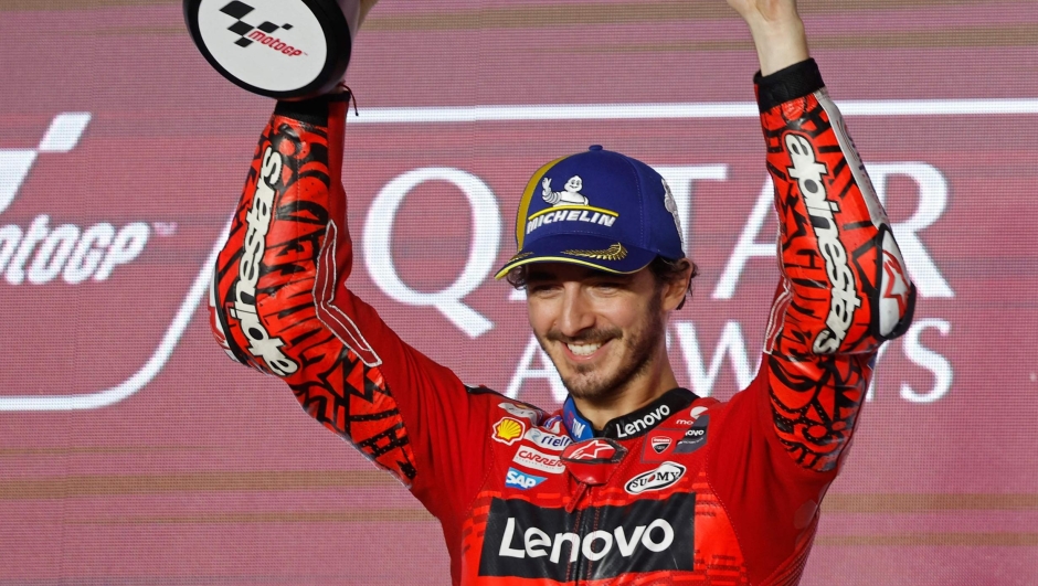 First placed Ducati Lenovo Team Italian rider Francesco Bagnaia celebrates with the trophy during the podium ceremony of the Qatar MotoGP Grand Prix at the Lusail International Circuit in Lusail, north of Doha on March 10, 2024. (Photo by KARIM JAAFAR / AFP)