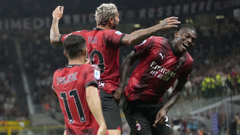 AC Milan's Theo Hernandez celebrates with his teammate AC Milan's Rafael Leao and Christian Pulisic after scoring his side's third goal during a Serie A soccer match between AC Milan and ,Torino at the San Siro stadium in Milan, Italy, Saturday, Aug. 26, 2023. (AP Photo/Luca Bruno)