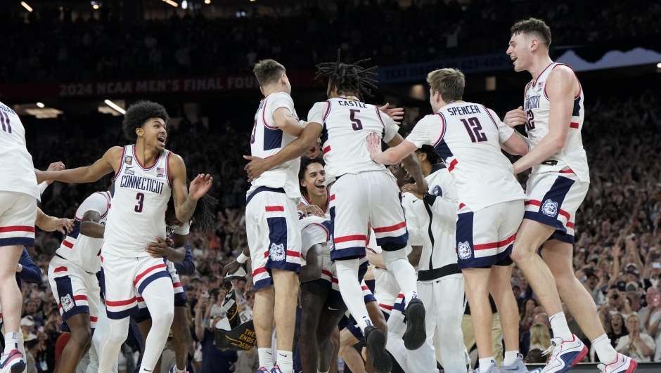 UConn celebrates their win against Purdue in the NCAA college Final Four championship basketball game, Monday, April 8, 2024, in Glendale, Ariz. (AP Photo/David J. Phillip)